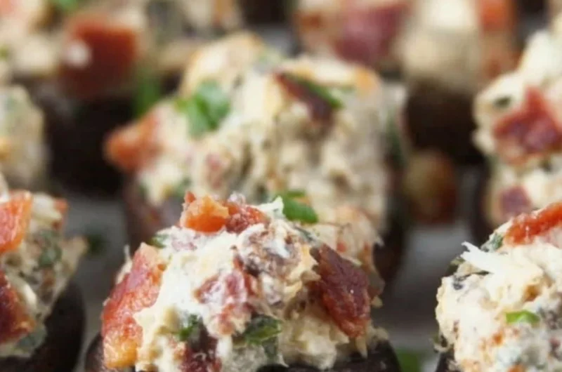 Stuffed mushrooms with bacon, cream cheese, and green onions on a serving platter