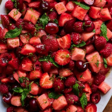Bowl of colorful watermelon fruit salad with mint and berries