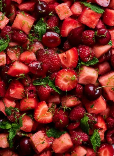 Bowl of colorful watermelon fruit salad with mint and berries