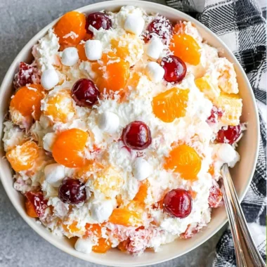 Cozy Ambrosia Salad served in a bowl with fresh fruits and creamy topping