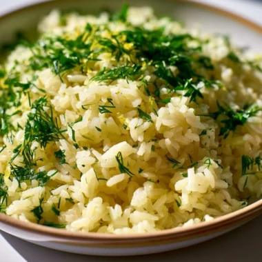 Delicious bowl of authentic Greek lemon rice garnished with fresh herbs