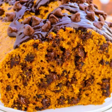 Delicious slice of chocolate chip pumpkin bread on a wooden table