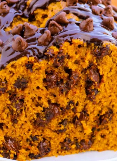 Delicious slice of chocolate chip pumpkin bread on a wooden table