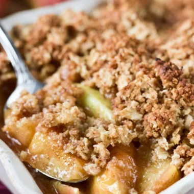 Delicious baked apple crisp topped with crispy oats and served warm