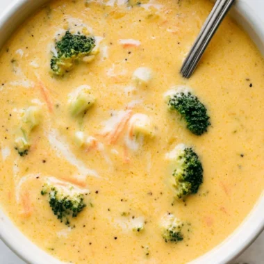 Creamy Broccoli Cheddar Soup garnished with fresh herbs