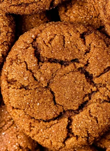 Freshly baked chewy gingersnap cookies on a cooling rack.