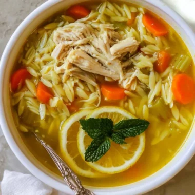Delicious Chicken Lemon Orzo Soup with fresh herbs and lemon slices