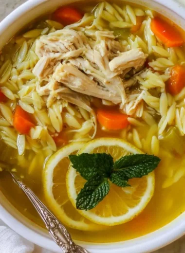 Delicious Chicken Lemon Orzo Soup with fresh herbs and lemon slices