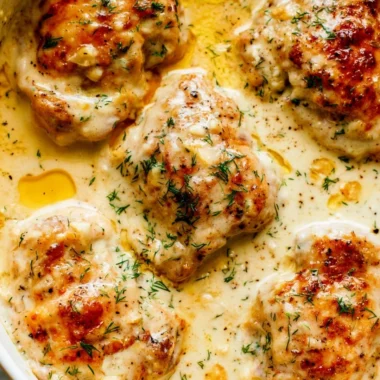 Creamy oven baked chicken thighs served with herbs and spices
