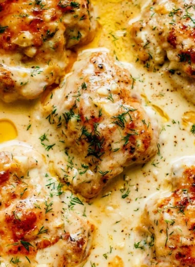 Creamy oven baked chicken thighs served with herbs and spices