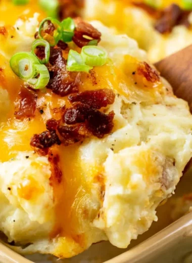 Delicious twice baked potato casserole topped with cheese and chives.